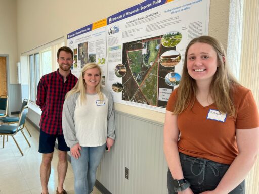 Studetnt and community members next to visioning poster