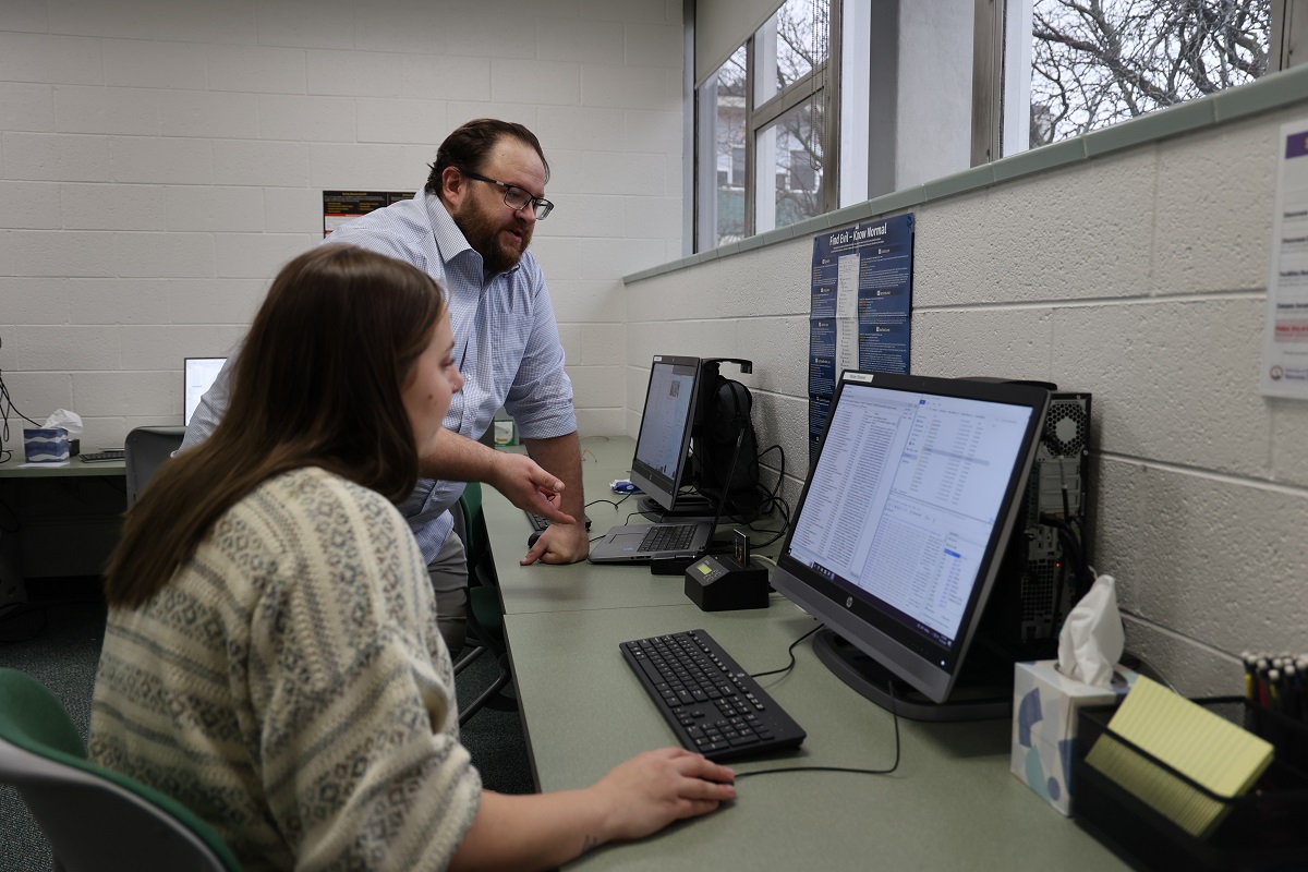 Assistant Professor Chad Johnson, CNMT, shows a student the data analysis software purchased for the Digital Forensics and Recovery Analysis Lab.